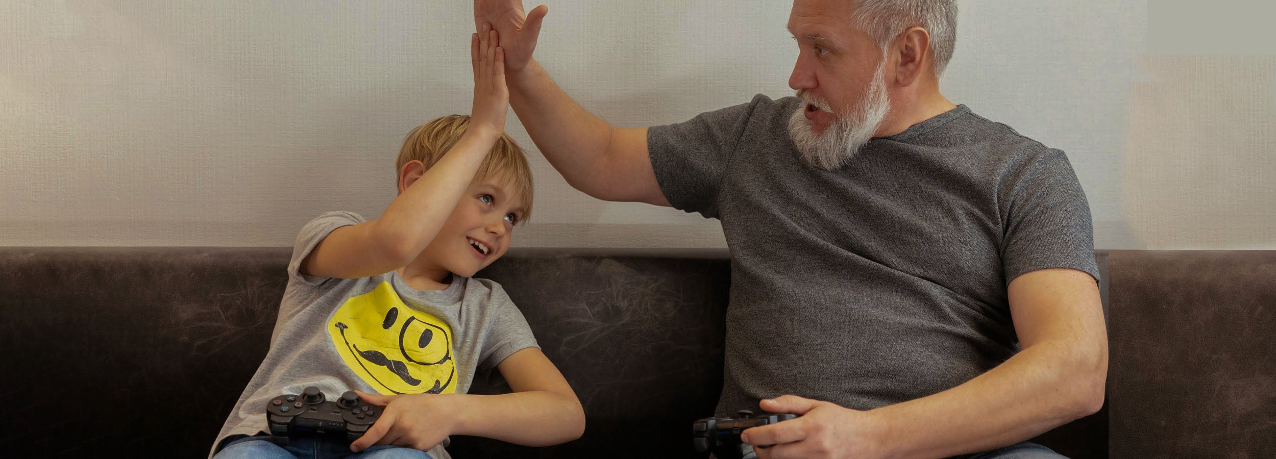 Grandfather and grandchild high-five to celebrate game win, Neenca's guide to keeping up with your kids and grandkids pain-free