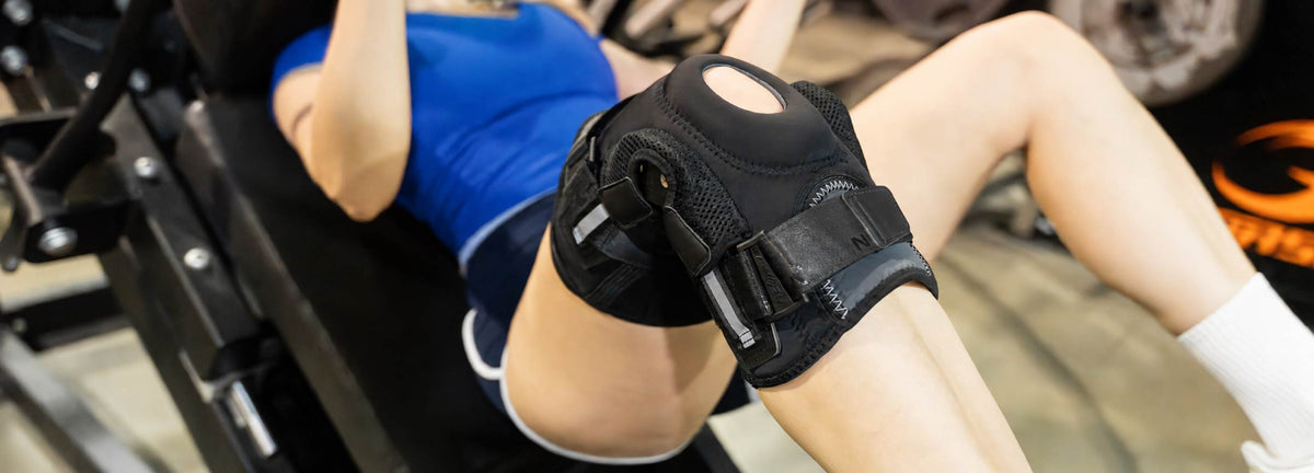 A woman is training at the gym wearing a Neenca hinged knee brace.