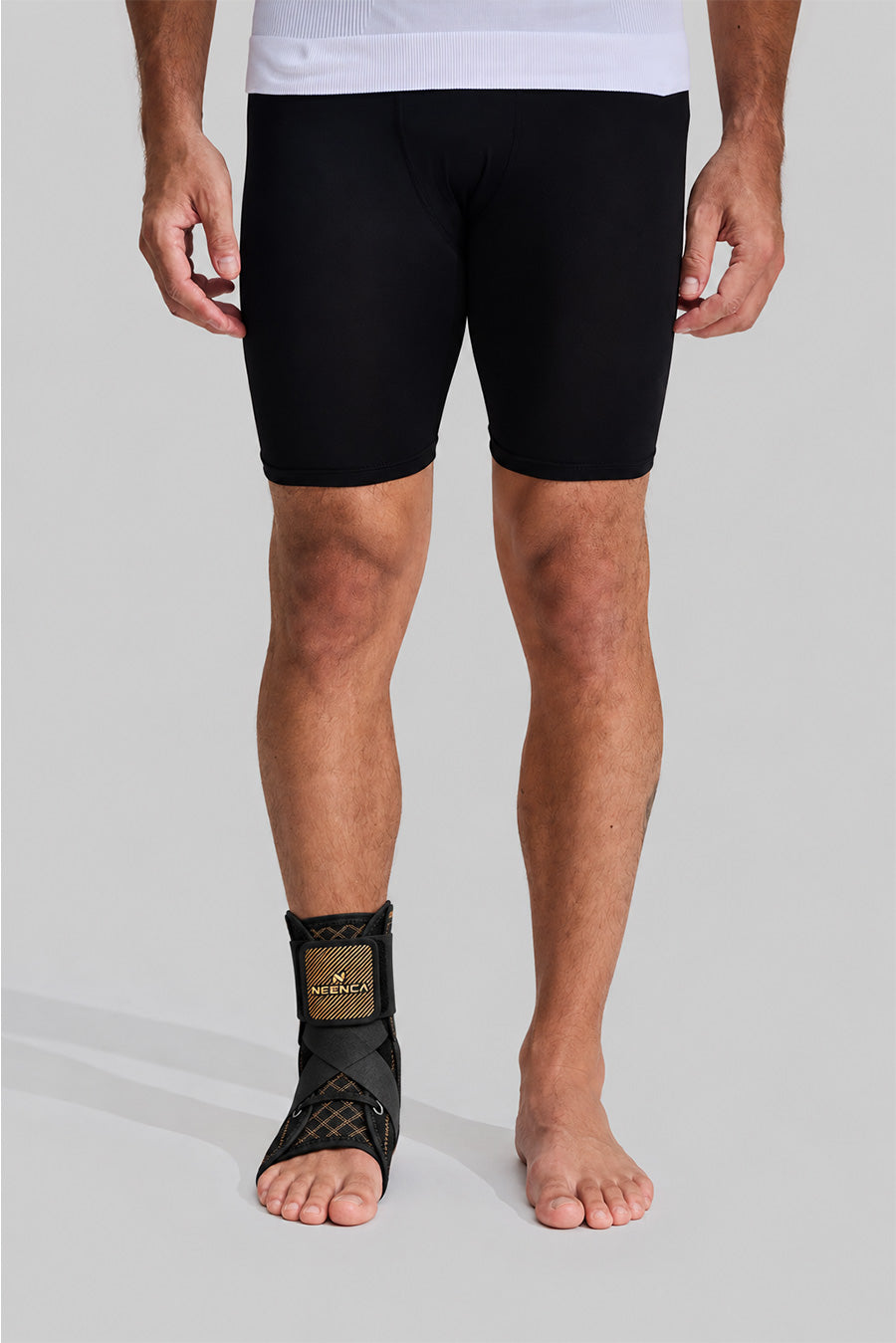 Man wearing NEENCA HH004 ankle brace, front view showing adjustable straps and ankle support design.