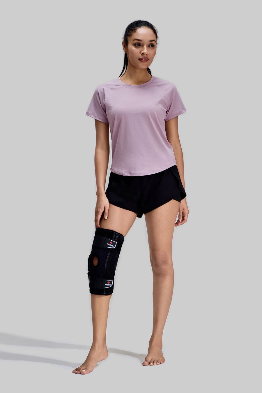 NEENCA Hinged Knee Brace HX042/HX035 worn by a female model on the right leg, full body front view showing sports support and stability