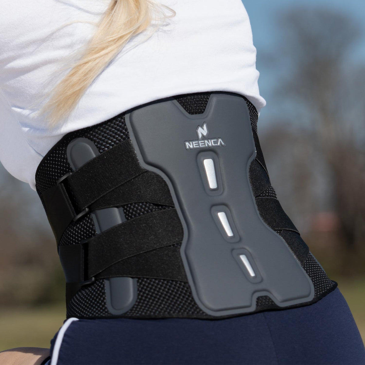 Woman wearing a NEENCA lower back support brace.