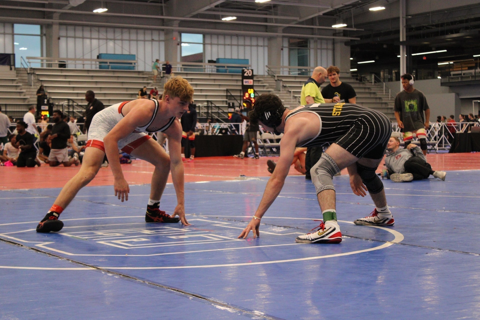 Wrestler maintaining a low stance during wrestling Match