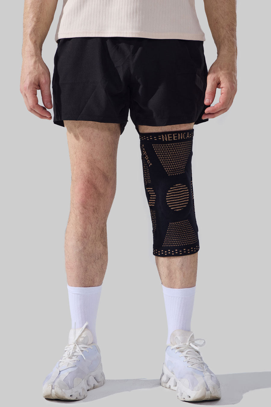 Front view of a man wearing a NEENCA ace-51 knee brace in copper.
