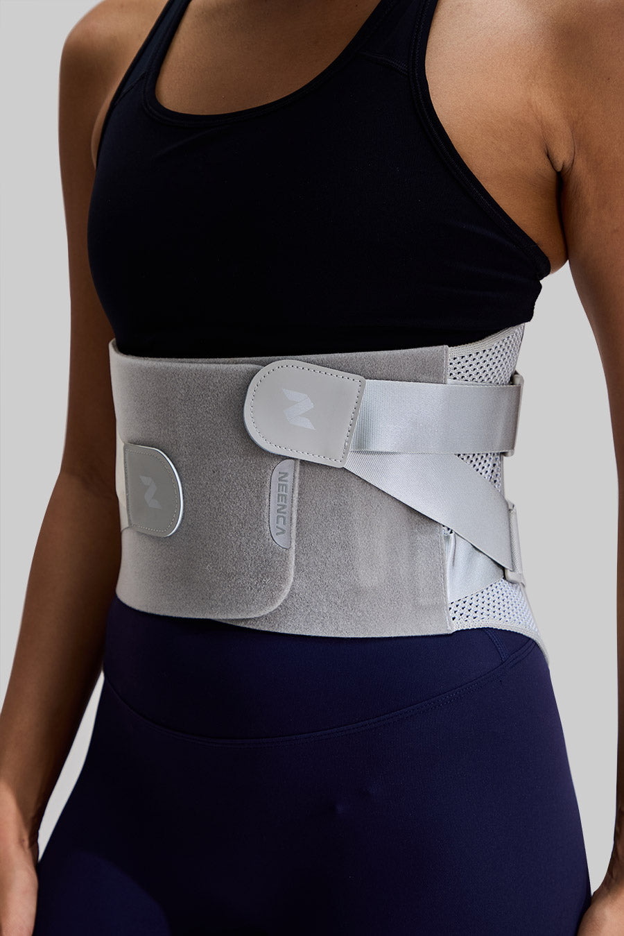 Side-angle view of NEENCA HY008 back brace on a model, highlighting the dual adjustable straps and breathable mesh side panels
