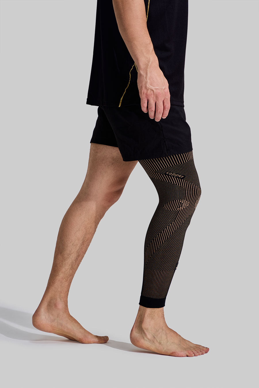 Side view of a man wearing a NEENCA compression leg sleeve from thigh to ankle.
